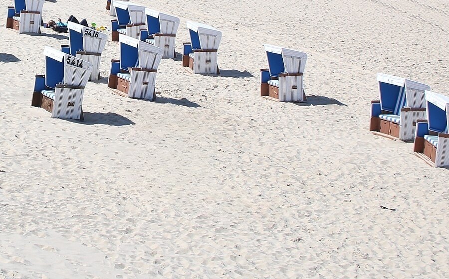 The same stretch of sand after removal, with no chair and no shadow where it stood